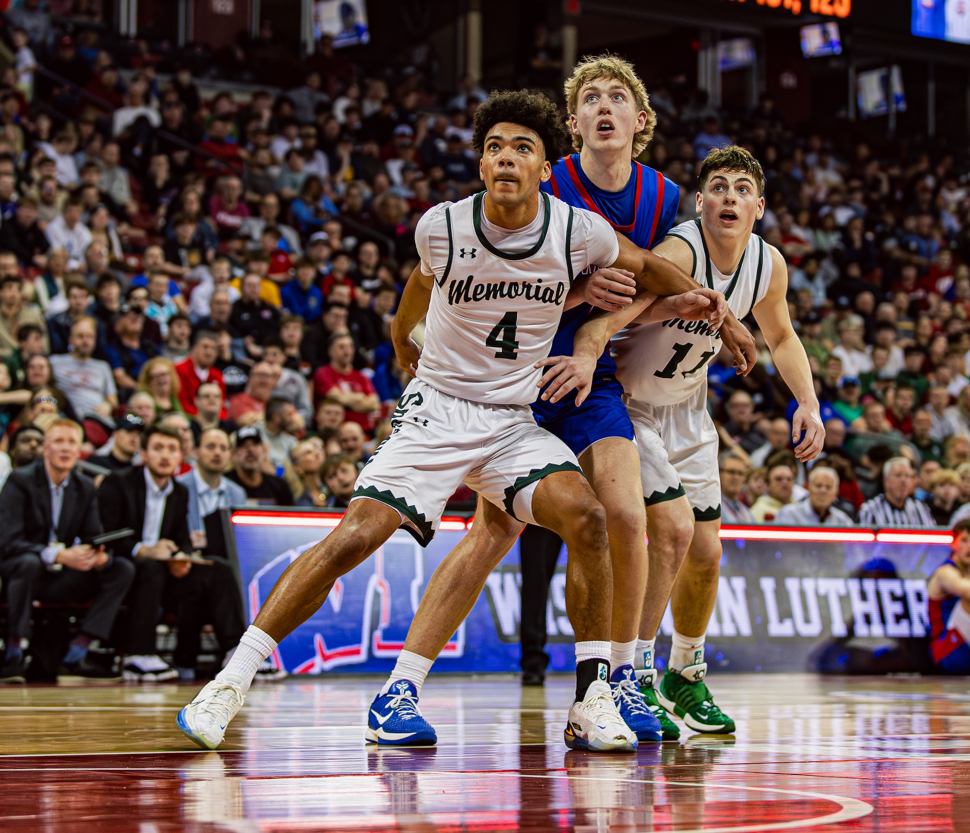 3 boys playing basketball