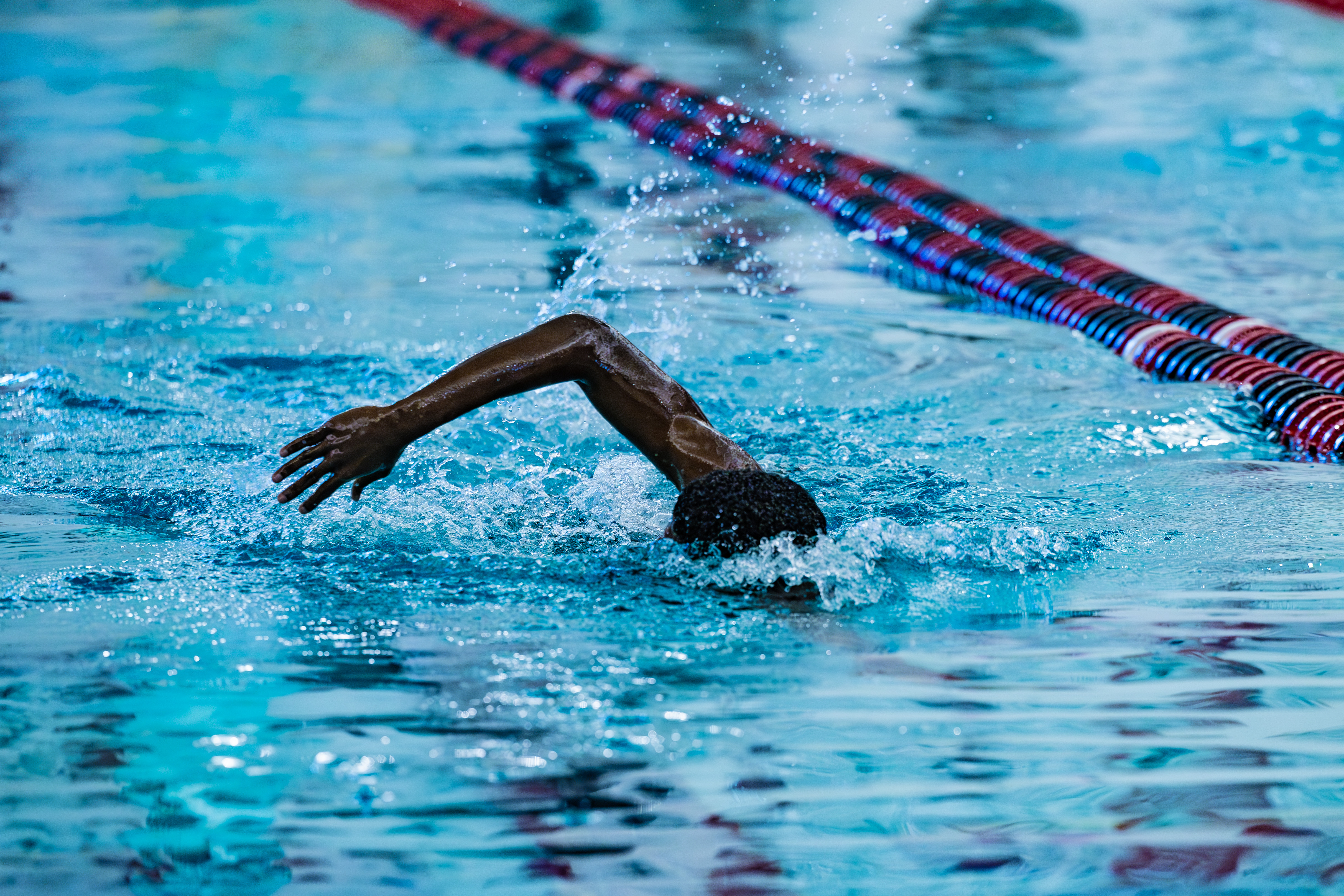 boys swimming lap in pool