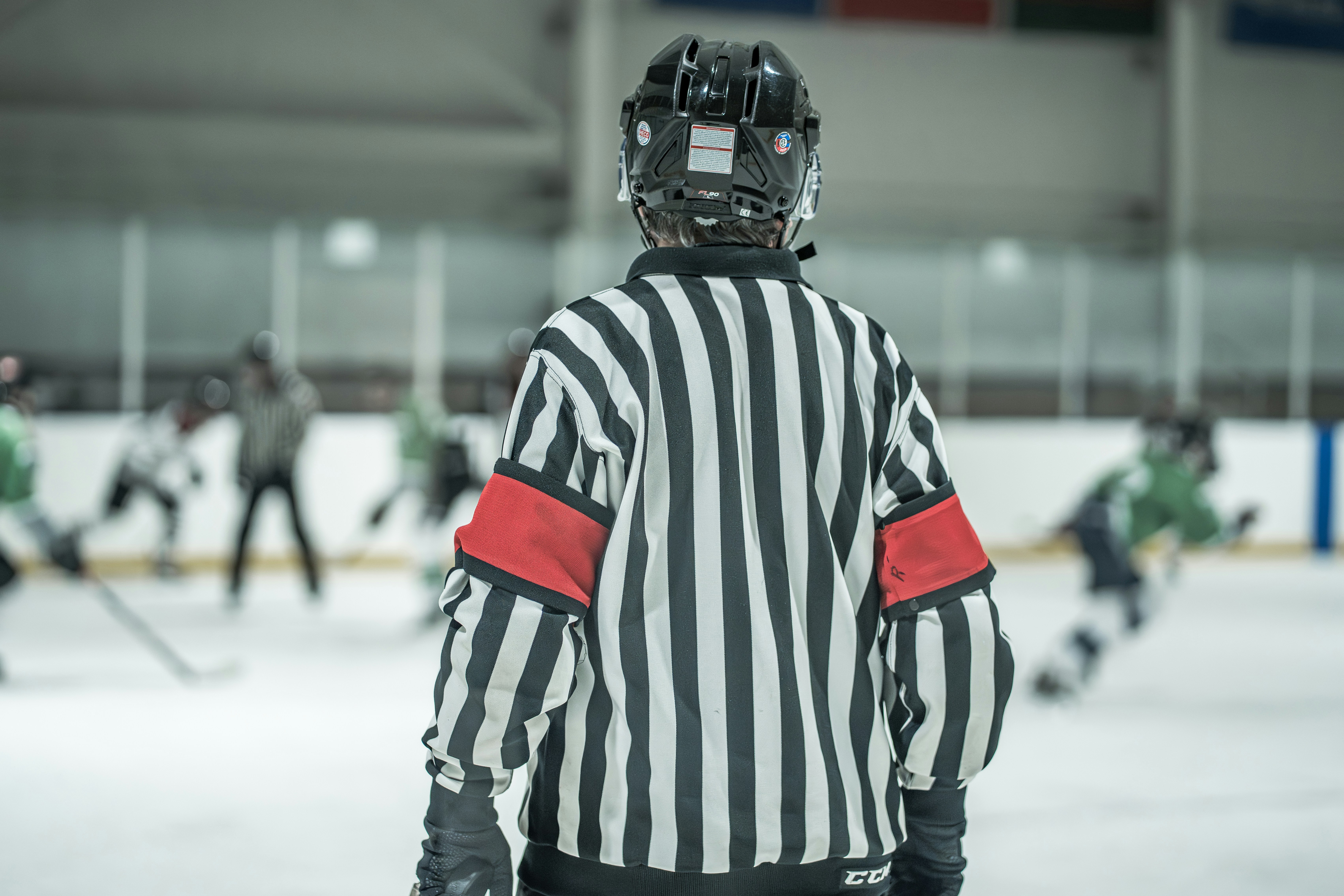 A hockey referee out on the ice during a game.